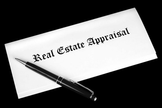 real estate appraisal documents and a pen